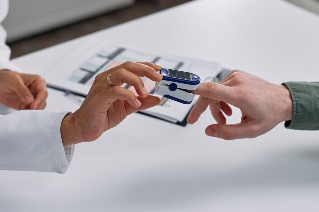 Close-up of Doctor Putting a Fingertip Pulse Oximeter on a Patients Finger